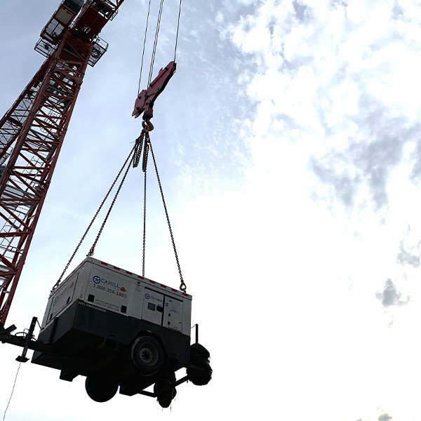 crane lifting a flameless heater for high rise construction