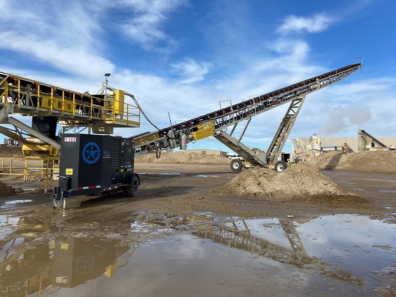 A rental unit in front of heavy machinery